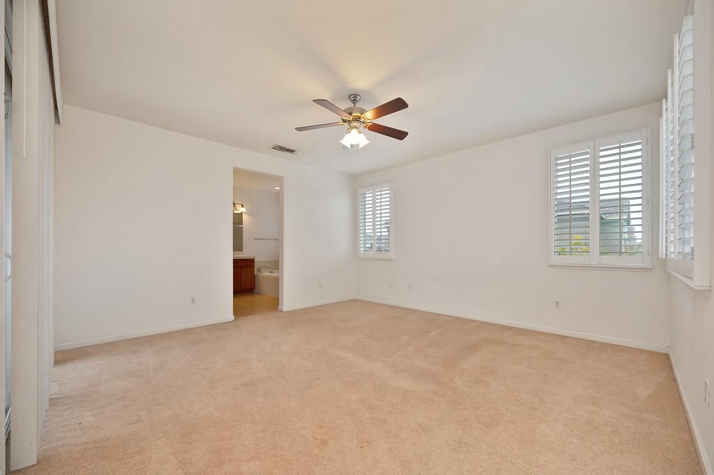 3505 Husch Way Rancho Cordova, CA 95670 - Photo 27 of 37 an empty room with chandelier fan and windows
