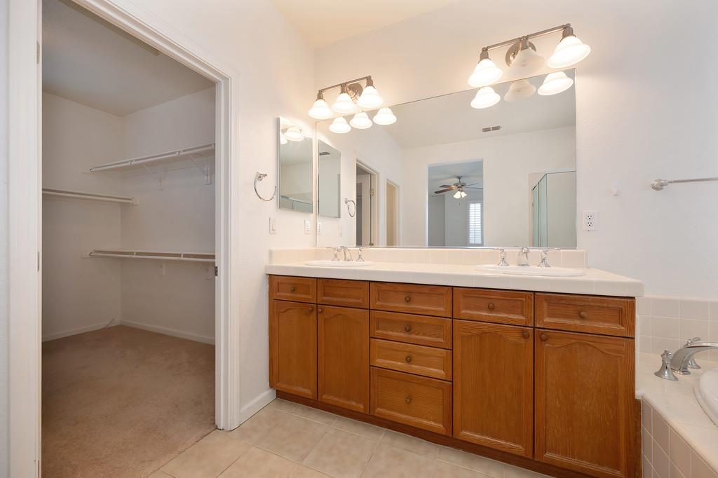 3505 Husch Way Rancho Cordova, CA 95670 - Photo 32 of 37 a bathroom with a double vanity sink and a mirror