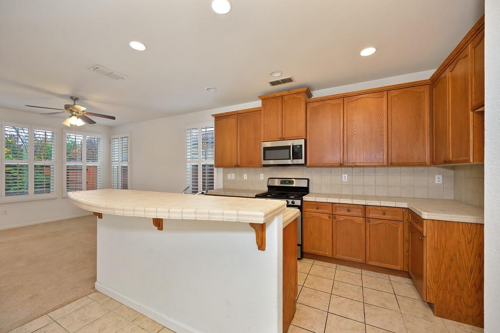 3505 Husch Way Rancho Cordova, CA 95670 - Photo 10 of 37 a kitchen with stainless steel appliances granite countertop a sink dishwasher stove top oven and cabinets
