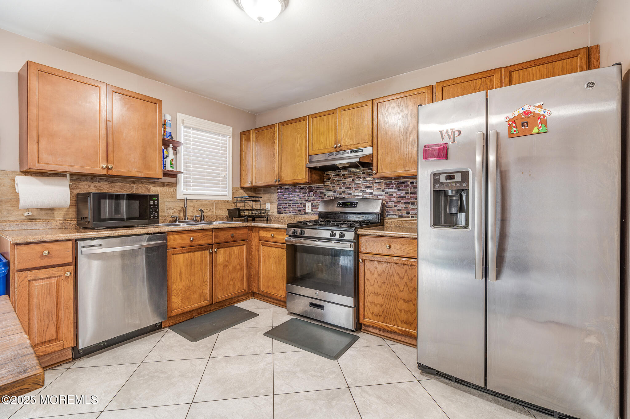207 Delaware Avenue Cliffwood, NJ 07721 - Photo 7 of 22 a kitchen with stainless steel appliances granite countertop a refrigerator sink and cabinets