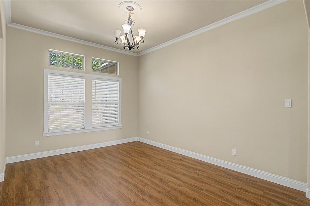 143 Wrigley Drive Springtown, TX 76082 - Photo 11 of 38 a view of empty room with wooden floor and fan