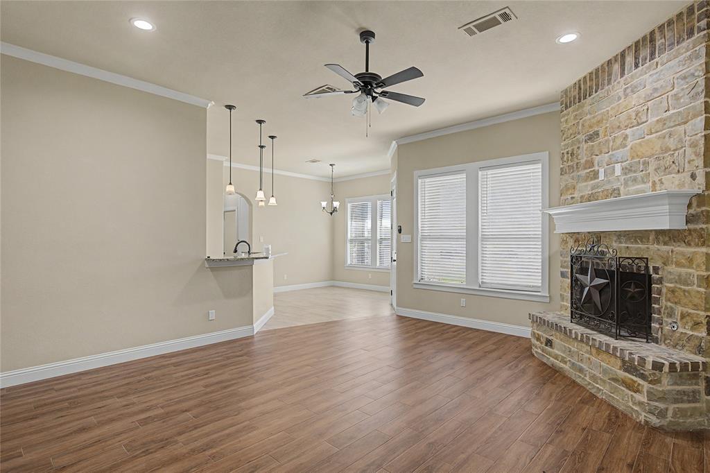 143 Wrigley Drive Springtown, TX 76082 - Photo 14 of 38 a view of an empty room with a fireplace and a window