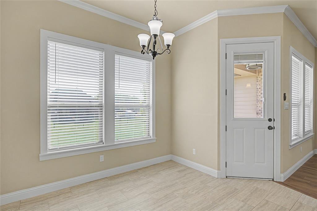 143 Wrigley Drive Springtown, TX 76082 - Photo 19 of 38 Breakfast area featuring arched walkways, ornamental molding, and suspended lighting