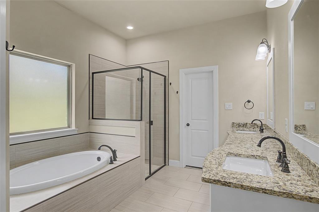 143 Wrigley Drive Springtown, TX 76082 - Photo 24 of 38 Primary Bathroom featuring double vanity, soaking tub, a separate shower