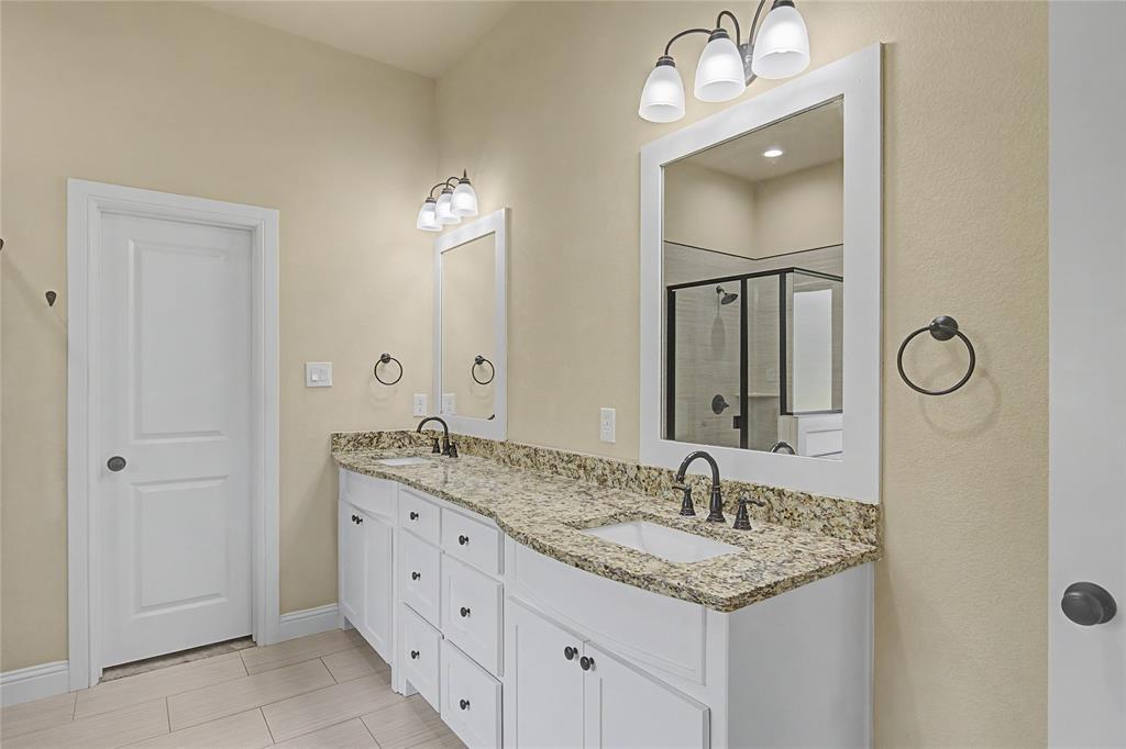 143 Wrigley Drive Springtown, TX 76082 - Photo 25 of 38 a bathroom with double sink and a mirror