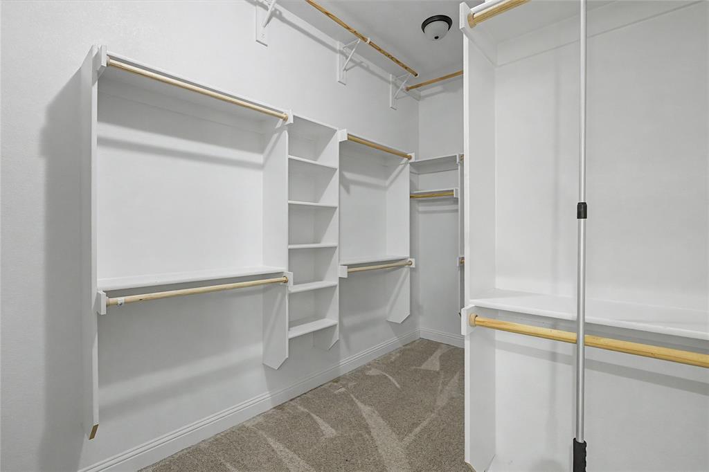 143 Wrigley Drive Springtown, TX 76082 - Photo 28 of 38 Primary bedroom walk-in closet. Triple rods for seasonal clothes