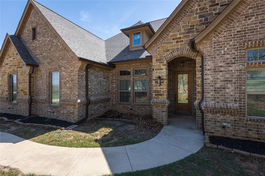 143 Wrigley Drive Springtown, TX 76082 - Photo 3 of 38 Welcoming Stone Arched Entry