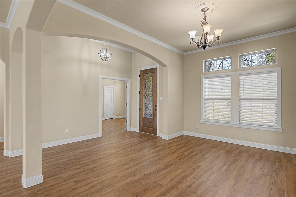 143 Wrigley Drive Springtown, TX 76082 - Photo 4 of 38 a view of livingroom with chandelier and wooden floor