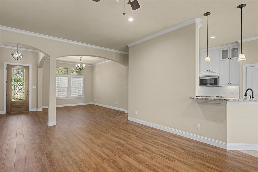 143 Wrigley Drive Springtown, TX 76082 - Photo 5 of 38 a view of a kitchen with wooden floor and a sink