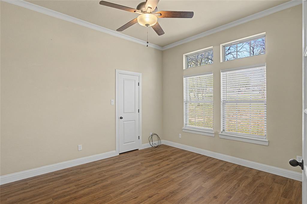 143 Wrigley Drive Springtown, TX 76082 - Photo 9 of 38 a view of an empty room with wooden floor and a window