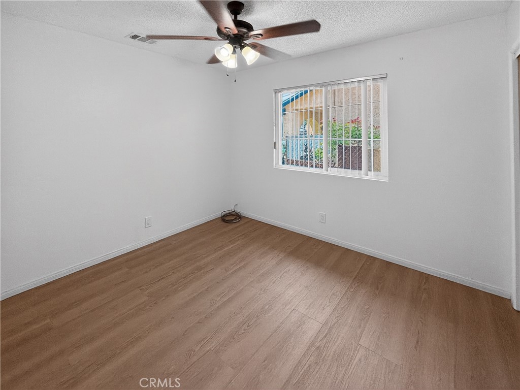 7451 Diamond Street Riverside, CA 92504 - Photo 18 of 31 wooden floor in an empty room with a window