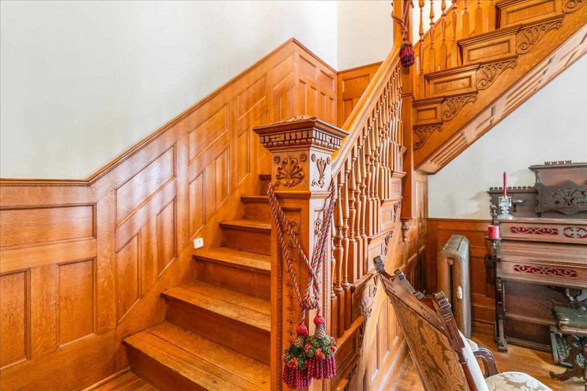 461 5th Street Manistee, MI 49660 - Photo 46 of 89 oak paneled wall leading upstairs