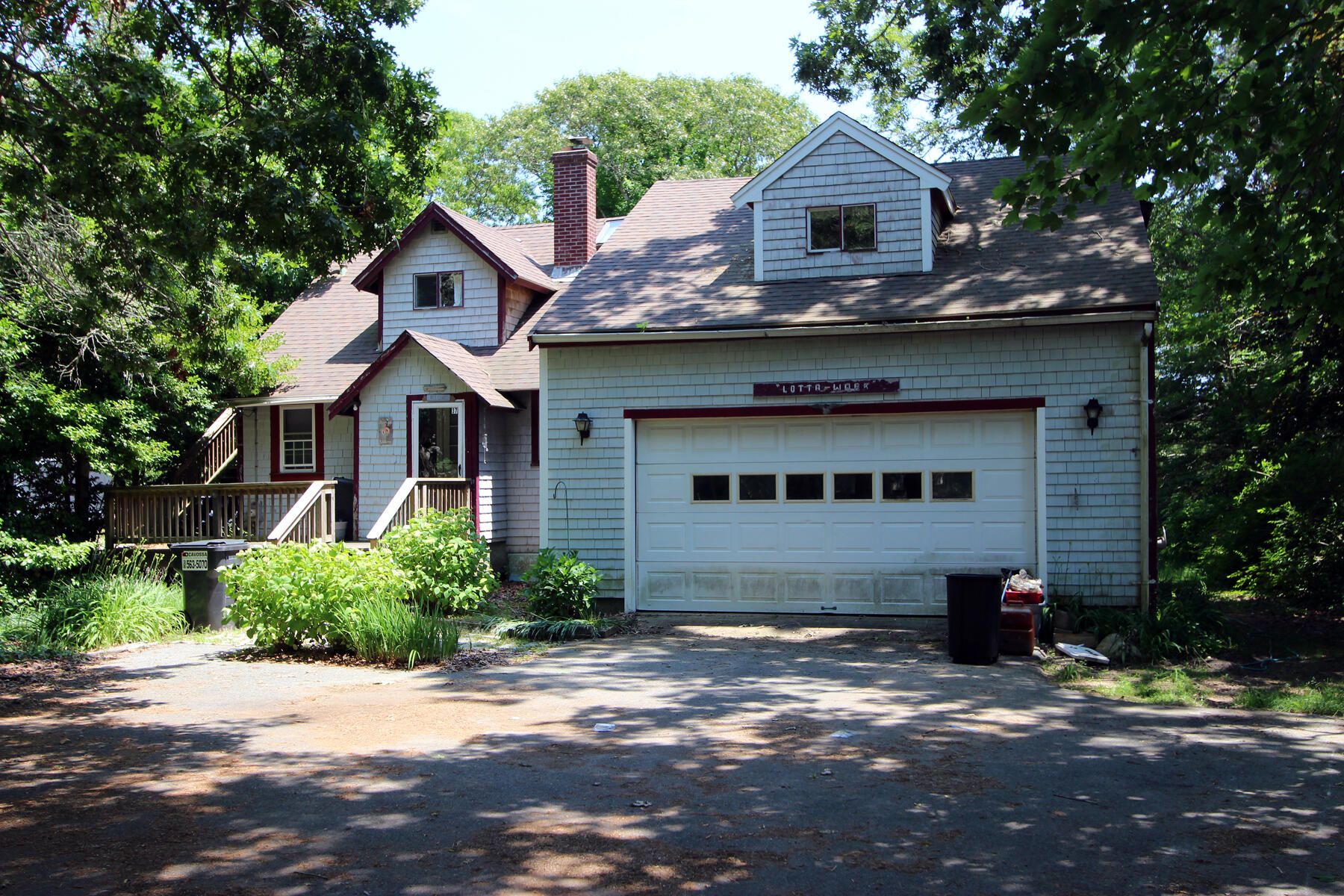 37 Riverside Road Mashpee, MA 02649 - Photo 1 of 19 a front view of a house with a garden