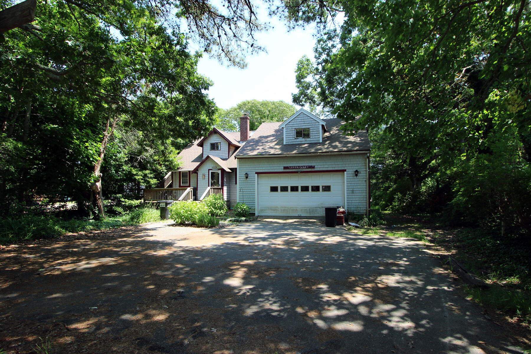 37 Riverside Road Mashpee, MA 02649 - Photo 3 of 19 a large tree in front of a house