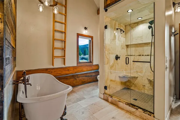 a bathroom with a bathtub and shower