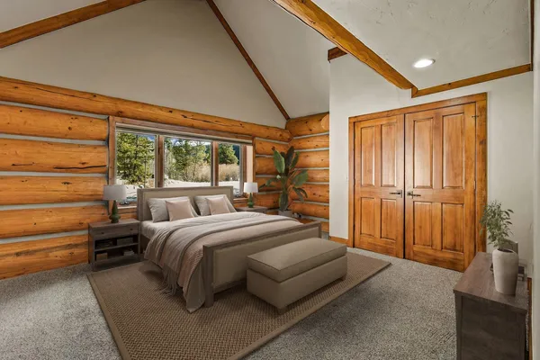 a bedroom with a bed and large windows