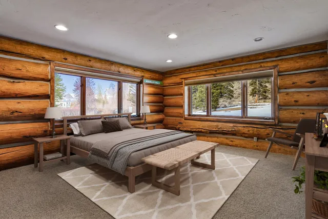 a bedroom with a bed and a large window