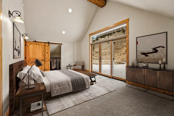 a bedroom with a bed and a mirror