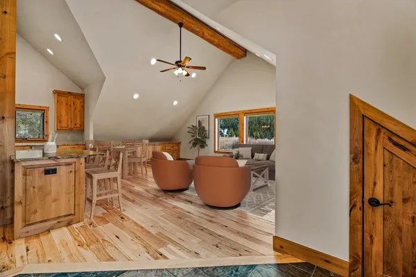 a living room with dining room and wooden floor