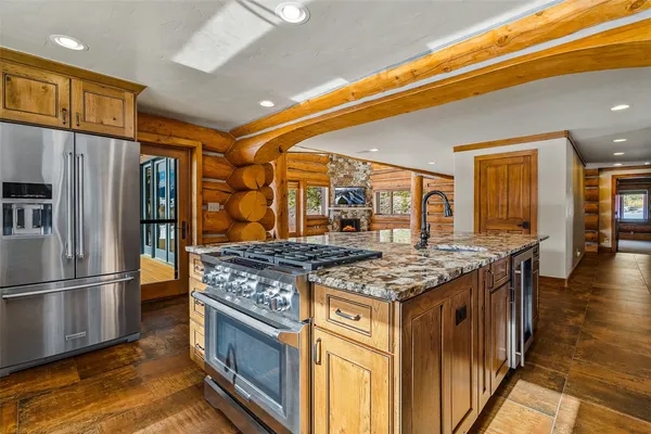 a kitchen with stainless steel appliances granite countertop a stove and a refrigerator