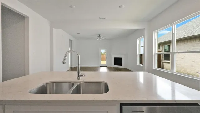 a kitchen with kitchen island a sink and a window