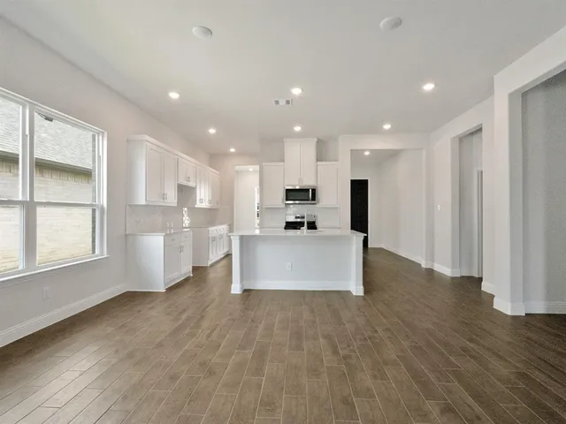 a view of kitchen with cabinets and wooden floor