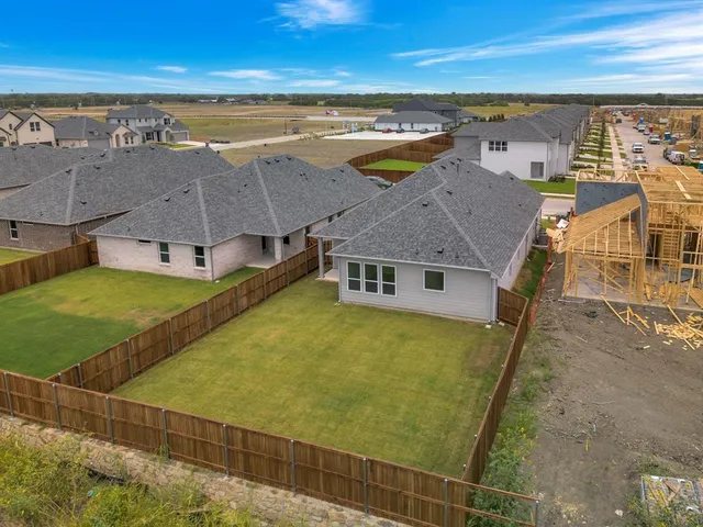 an aerial view of residential houses with outdoor space