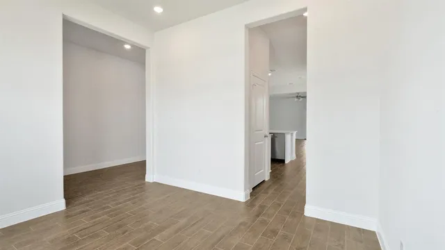 a view of a hallway with wooden floor
