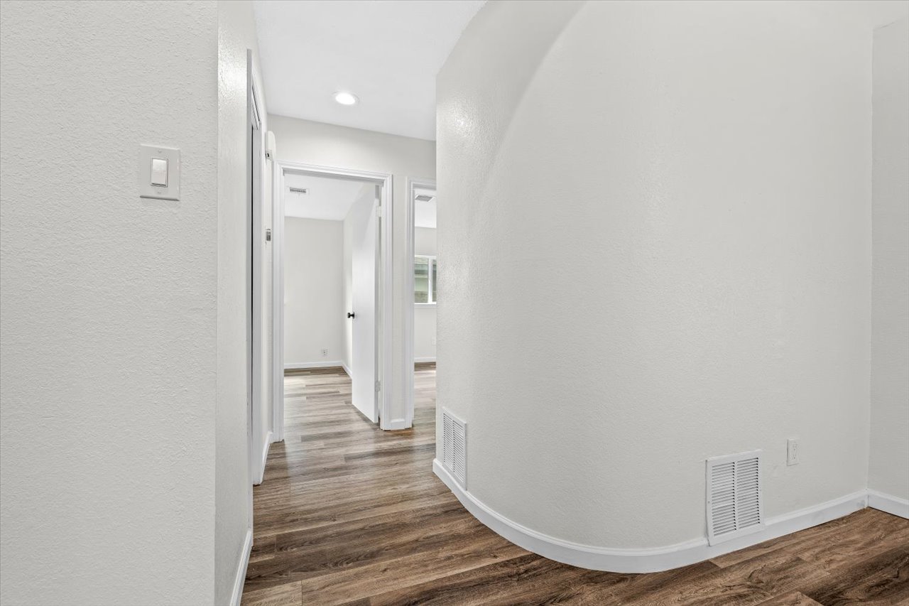 4004 Danli Lane Austin, TX 78749 - Photo 10 of 40 a view of a hallway with wooden floor and staircase