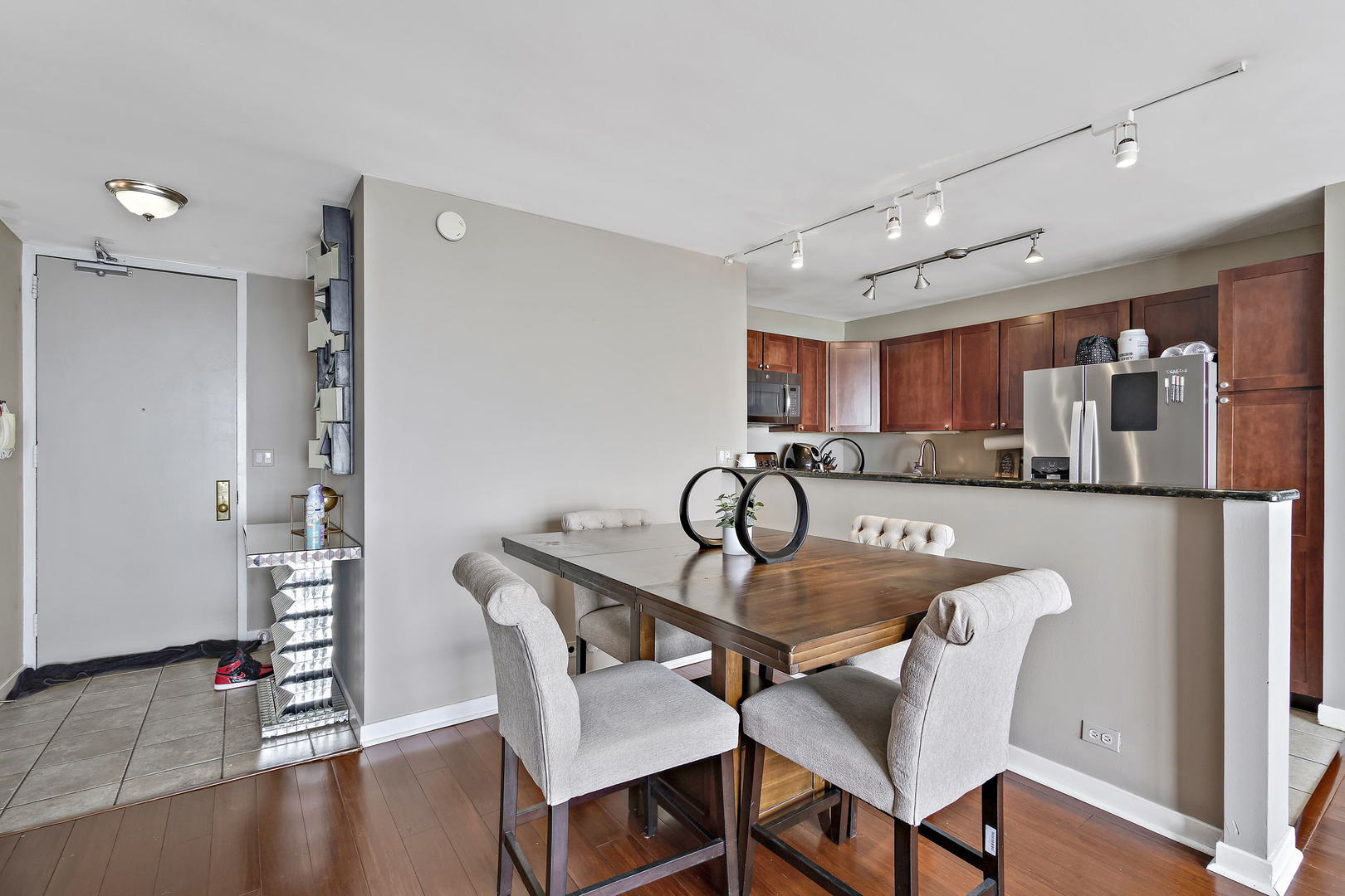 655 West Irving Park Road, Unit 4108 Chicago, IL 60613 - Photo 2 of 32 a view of a dining room with furniture and wooden floor