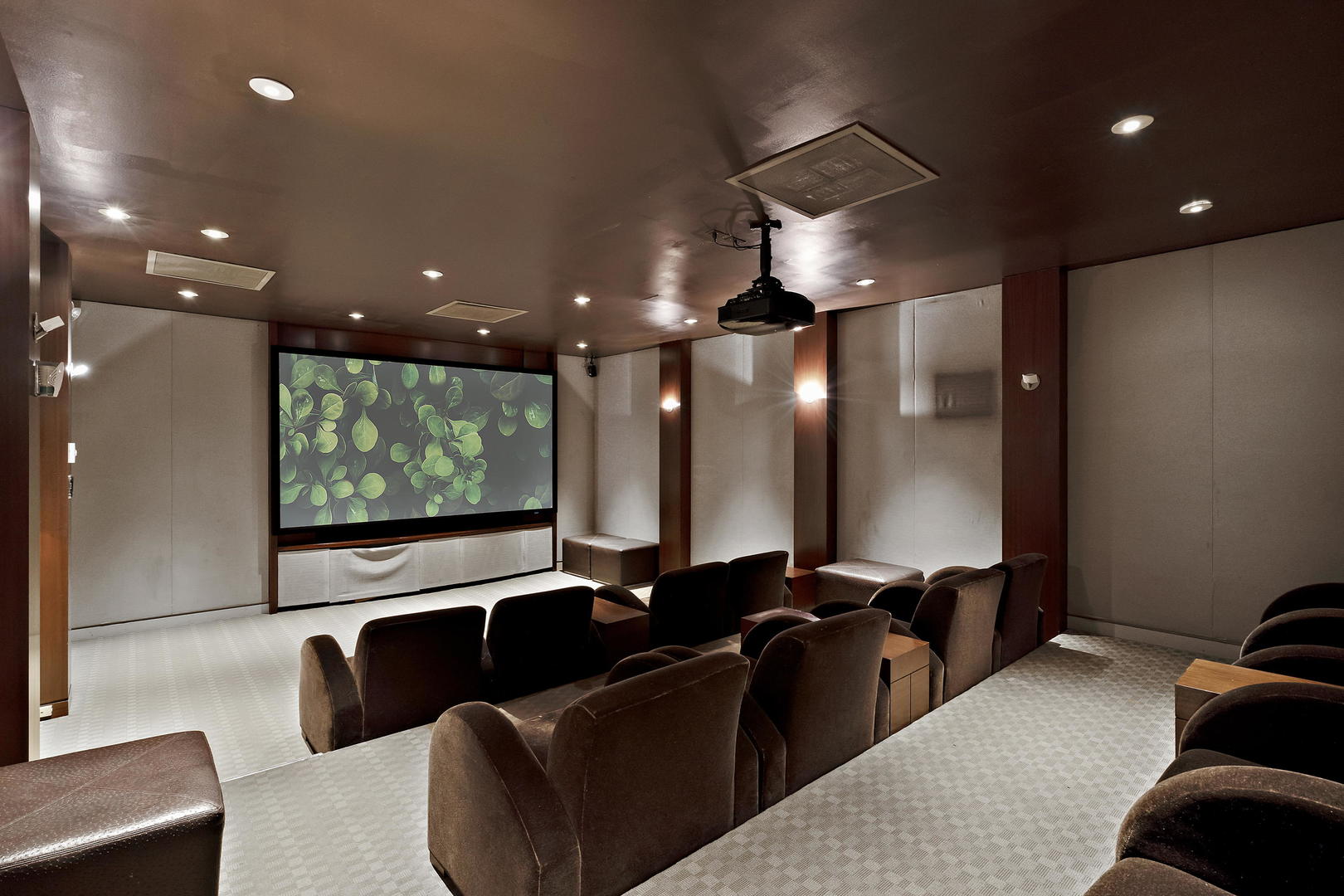 655 West Irving Park Road, Unit 4108 Chicago, IL 60613 - Photo 30 of 32 a projector room with large couches and projector