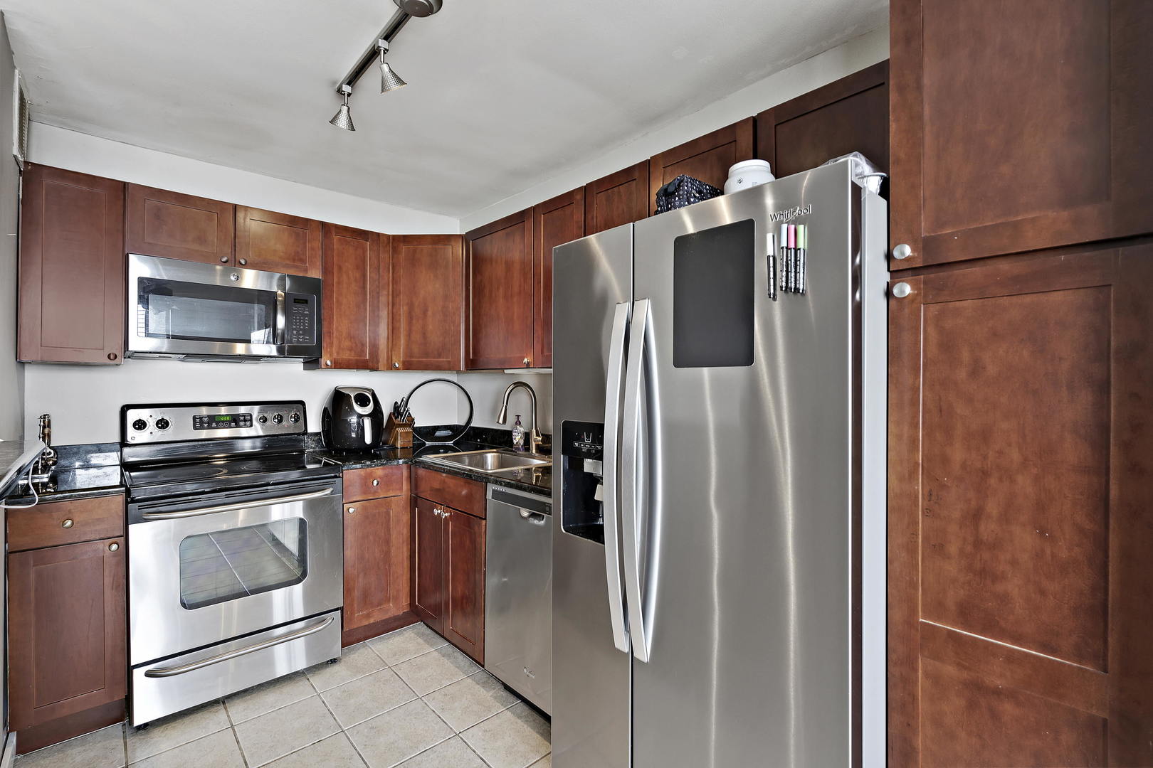 655 West Irving Park Road, Unit 4108 Chicago, IL 60613 - Photo 8 of 32 a kitchen with stainless steel appliances granite countertop a refrigerator a stove top oven a sink and dishwasher
