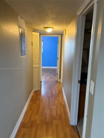 a view of a hallway with wooden floor