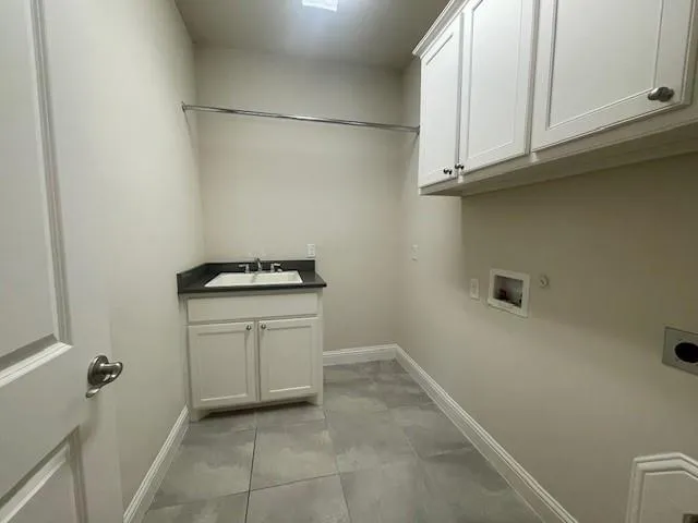 a bathroom with a granite countertop sink and cabinets