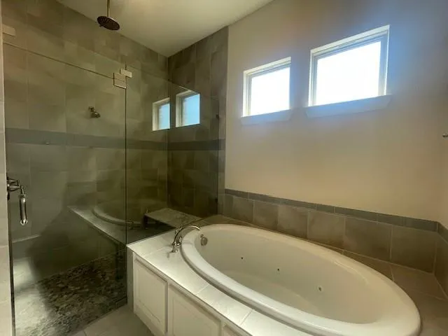 a bath tub sitting next to a toilet and a shower