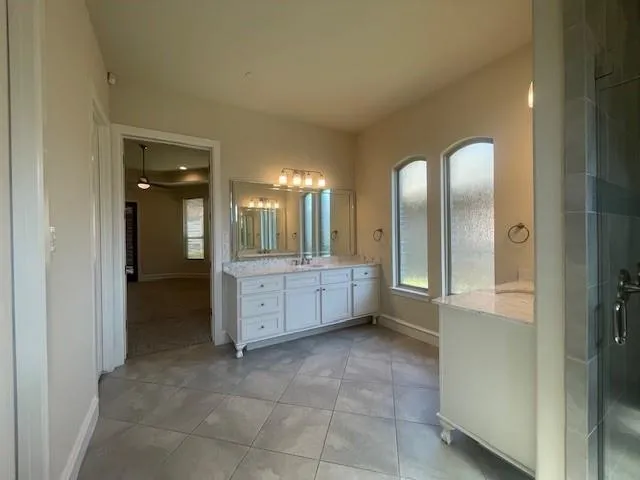 a bathroom with a mirror and a shower