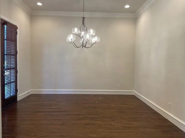 a view of wooden floor and chandelier in living room