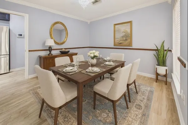 a view of a dining room with furniture and wooden floor