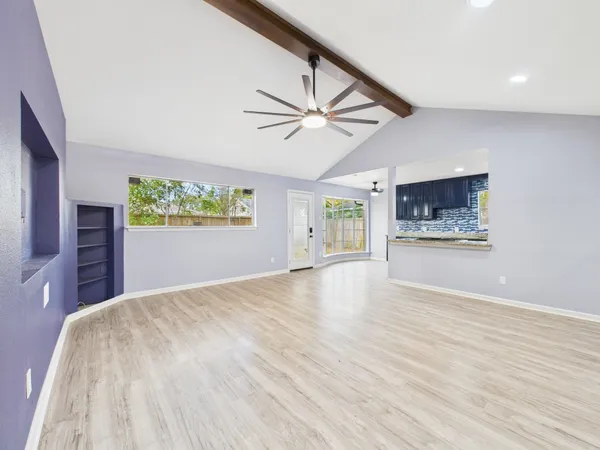 a view of a livingroom with a ceiling fan and window