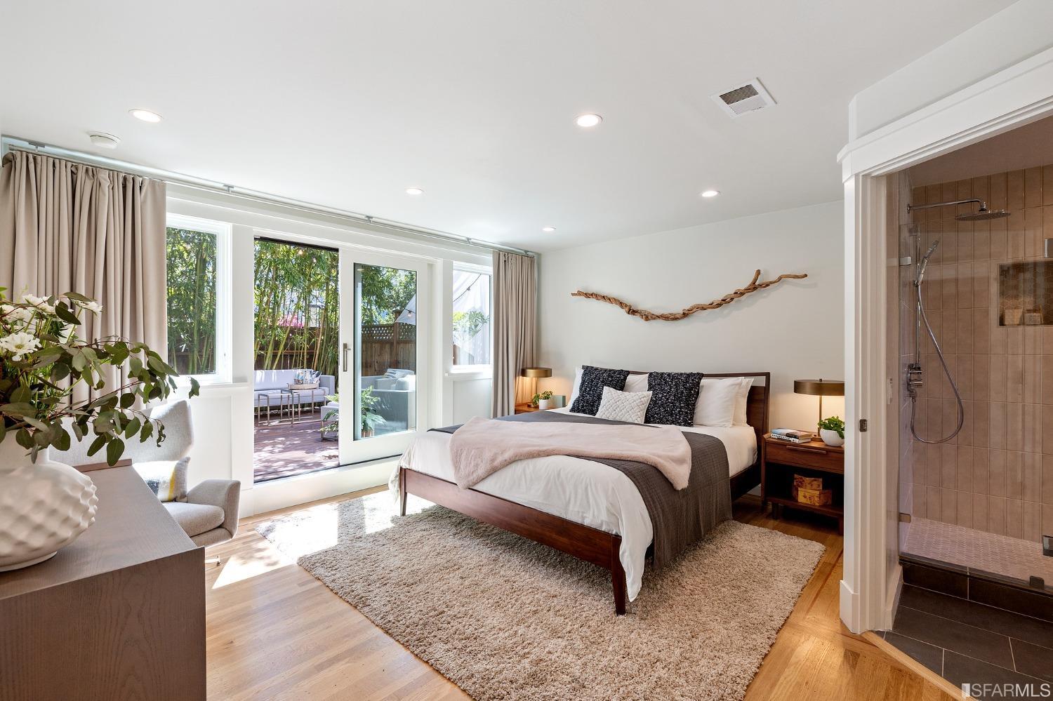 115 Wool Street San Francisco, CA 94110 - Photo 11 of 37 a spacious bedroom with a large bed and a potted plant