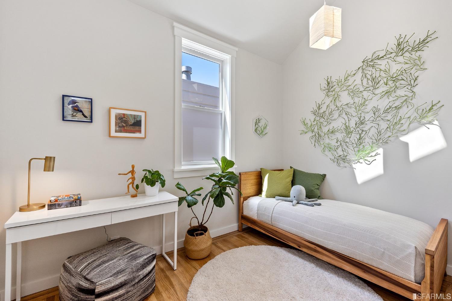 115 Wool Street San Francisco, CA 94110 - Photo 16 of 37 a bedroom with a bed and a chandelier