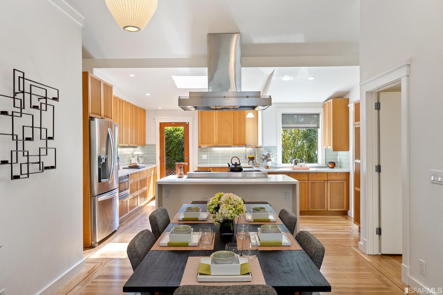 115 Wool Street San Francisco, CA 94110 - Photo 2 of 37 a kitchen with a table chairs refrigerator and stove