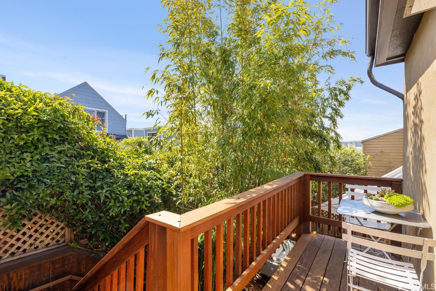 115 Wool Street San Francisco, CA 94110 - Photo 22 of 37 a balcony with wooden floor and yard in the back