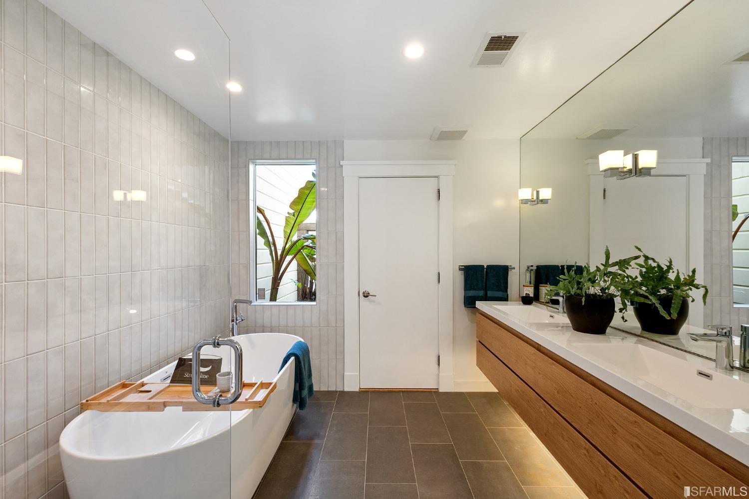 115 Wool Street San Francisco, CA 94110 - Photo 27 of 37 a bathroom with a tub sink and mirror