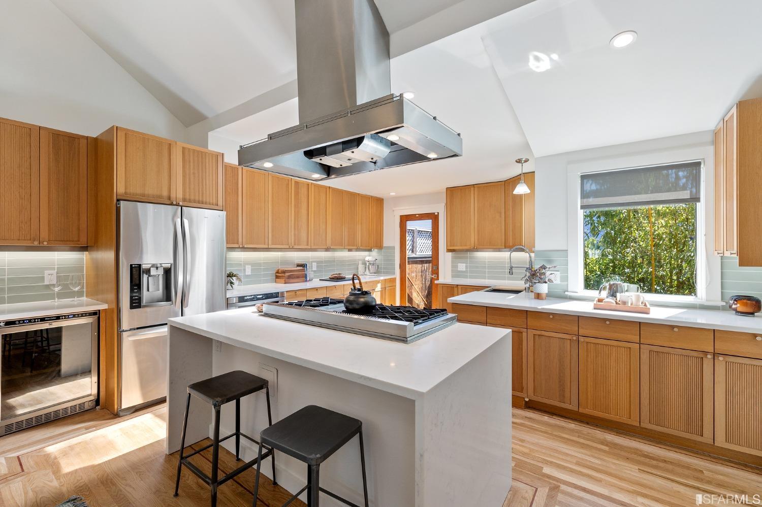 115 Wool Street San Francisco, CA 94110 - Photo 3 of 37 a kitchen with stainless steel appliances a sink a stove a refrigerator cabinets and wooden floor