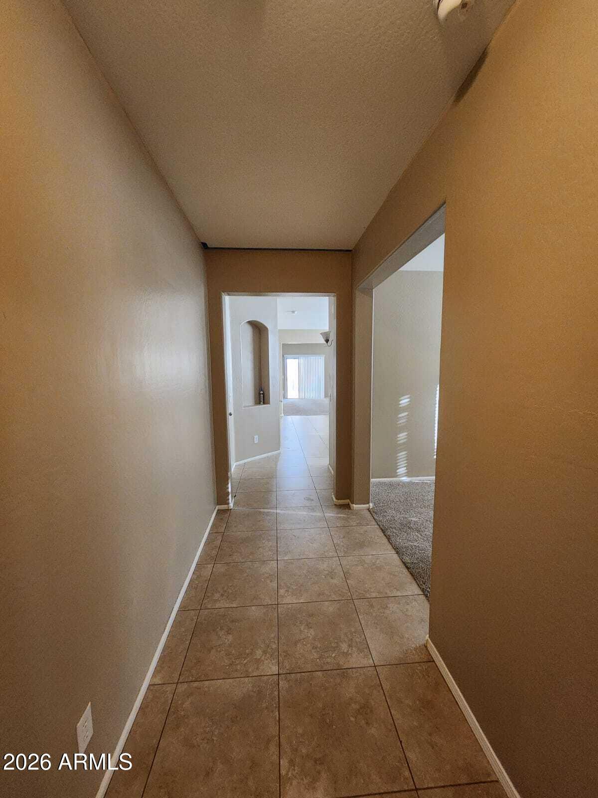 7643 West Charter Oak Road Peoria, AZ 85381 - Photo 11 of 27 a view of a hallway with wooden floor and a bathroom