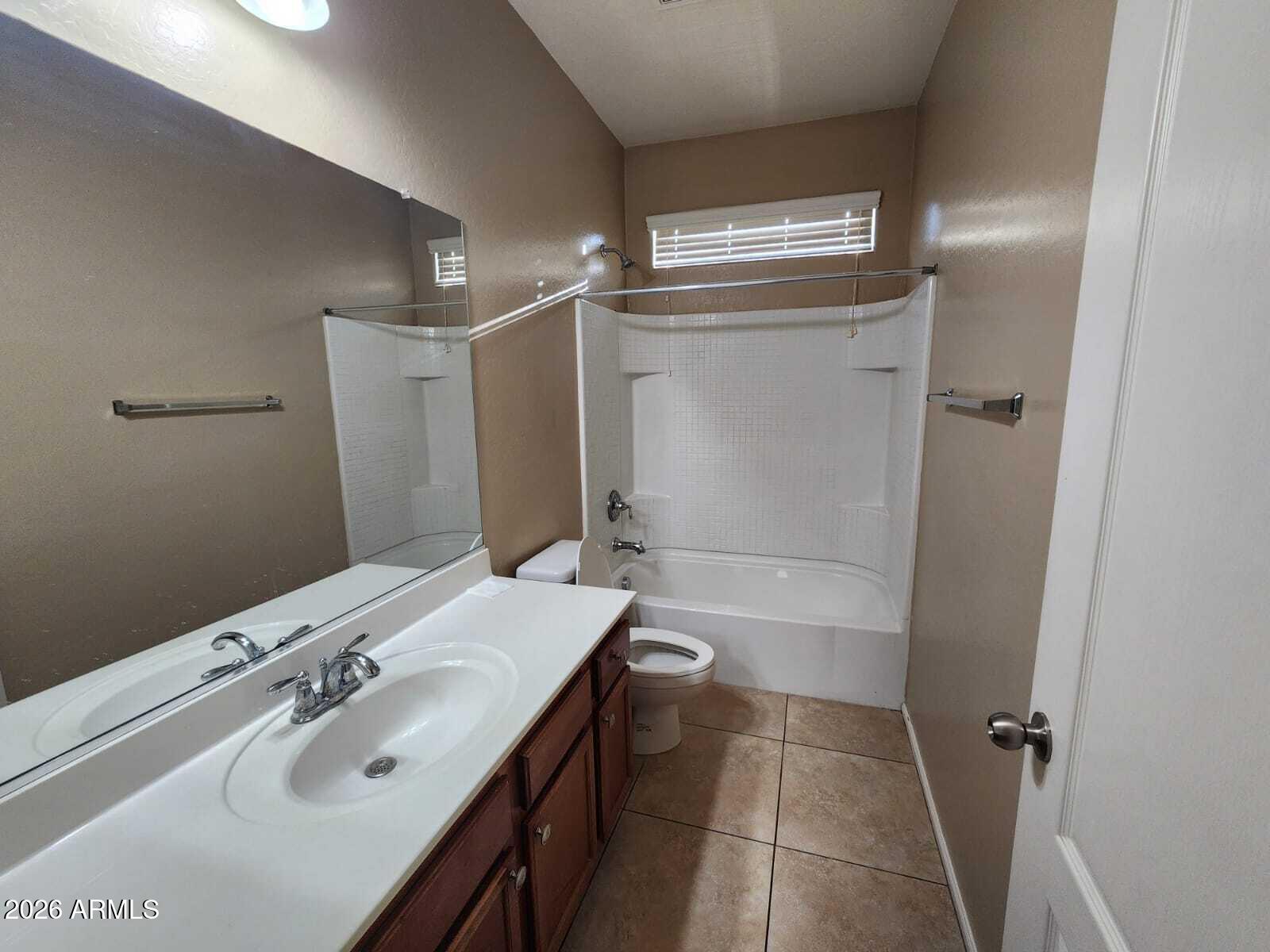 7643 West Charter Oak Road Peoria, AZ 85381 - Photo 12 of 27 a bathroom with a sink and a mirror