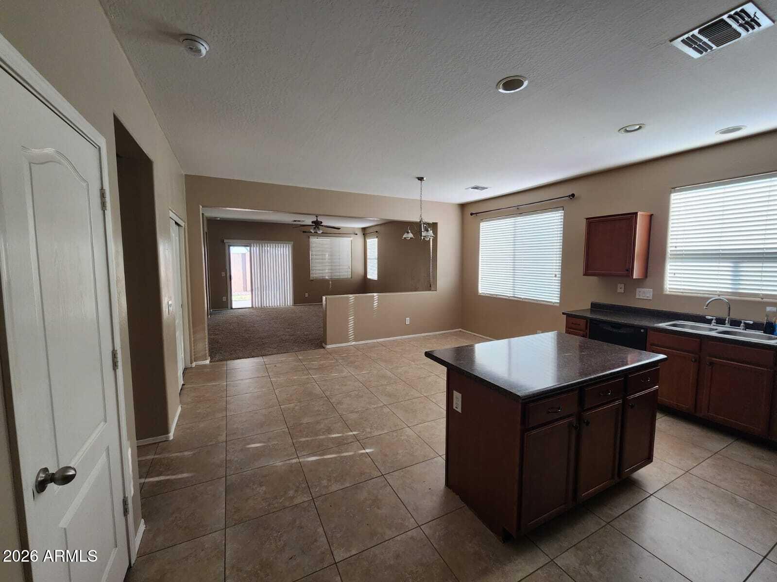 7643 West Charter Oak Road Peoria, AZ 85381 - Photo 16 of 27 a kitchen with a stove a sink and a refrigerator