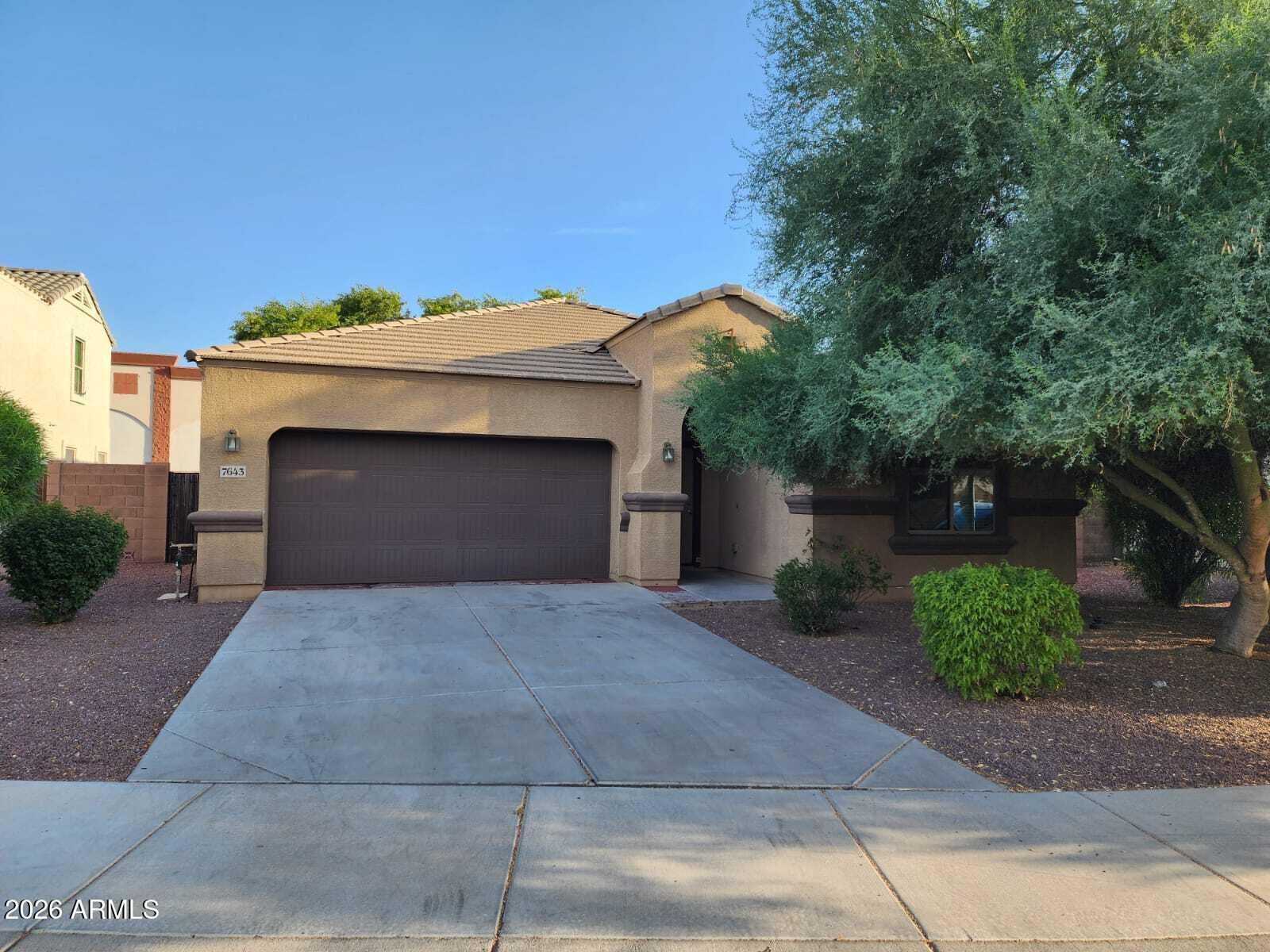 7643 West Charter Oak Road Peoria, AZ 85381 - Photo 2 of 27 a front view of a house with a yard and garage
