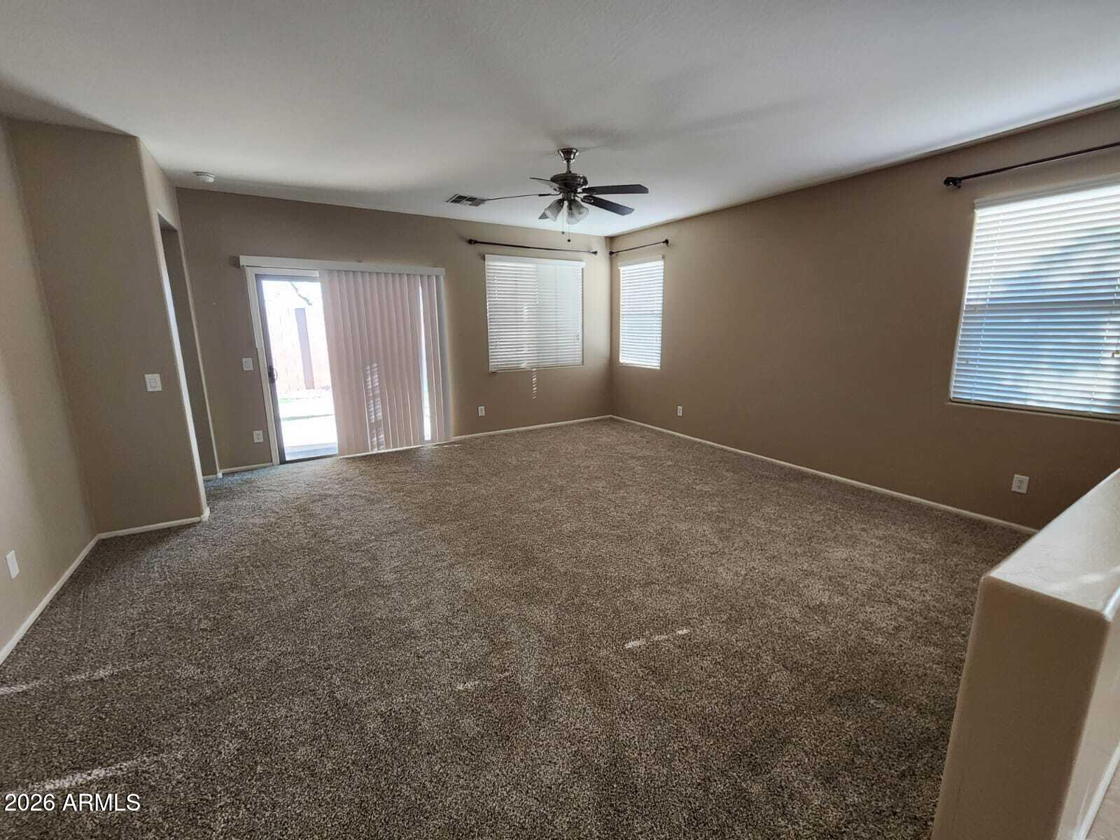 7643 West Charter Oak Road Peoria, AZ 85381 - Photo 21 of 27 an empty room with windows and fan